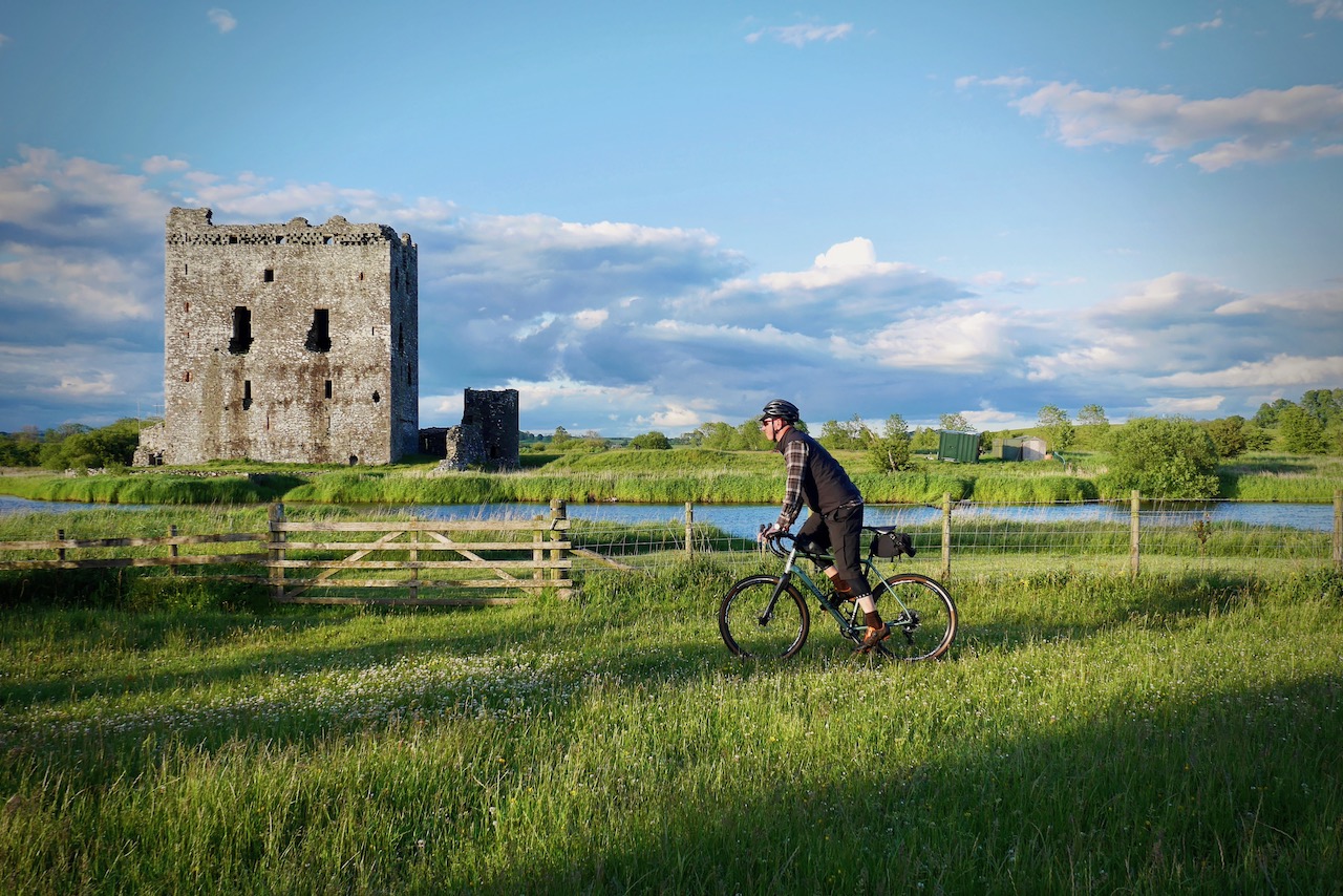 cyclist passing castle on cycle routes
